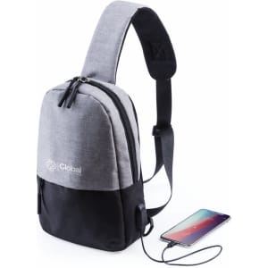 A grey and black shoulder bag with a single strap and a logo, featuring a zippered compartment and a charging port.