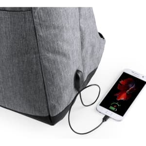 A grey backpack with a USB charging port, connected to a smartphone displaying a battery icon.
