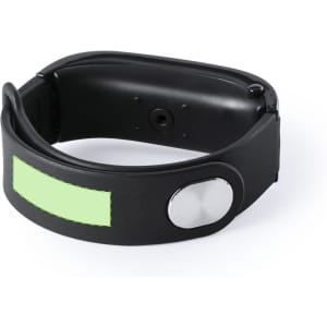 A black smart bracelet featuring a silver button and a light green panel, designed for tech use.