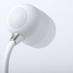 A white multifunction lamp with a rounded design and a metallic accent on the base, featuring a wireless charger.