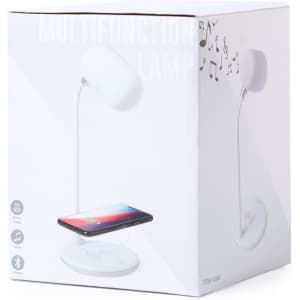 A white multifunction lamp with a wireless charging base and Bluetooth features in a promotional box.