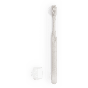 A toothbrush in a soft grey colour alongside a small, white case. The toothbrush features a textured head and has a logo.