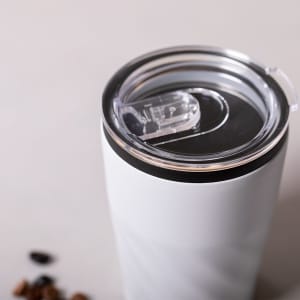 A drink bottle featuring a white insulated cup with a clear lid and a black base, designed for travel use.