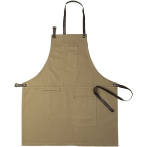 A khaki apron with multiple pockets and leather straps. Features branding on the fabric.
