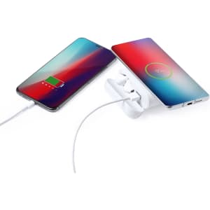 A white power bank with earphones connected, charging two smartphones with colourful screens.