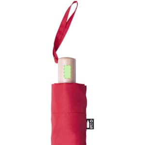 A red umbrella with a wooden handle, stored in a matching red protective sleeve. It features a logo on the sleeve.