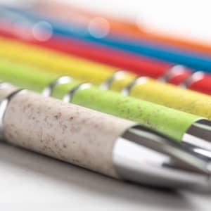 A row of pens in various vibrant colours, featuring a mix of smooth and textured finishes, with metallic accents.