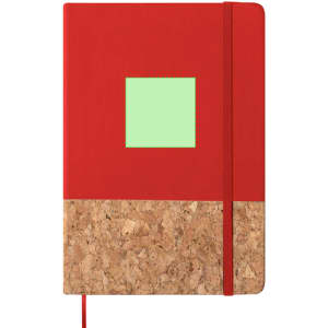 A red notepad with a cork bottom and a green square on the front, featuring an elastic closure and ribbon marker.