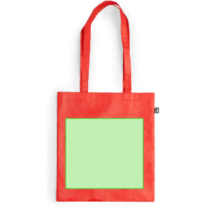 A reusable grocery bag in bright red with two long handles and a large, blank green panel on the front.