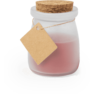 A glass jar candle with a cork lid, featuring a pink wax interior and a simple tag attached.