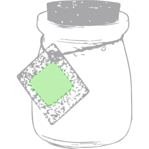 A glass candle jar with a grey lid and a green tag, featuring a textured design.