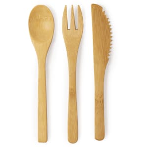 A bamboo cutlery set featuring a spoon, fork, and serrated knife, all in a natural finish.