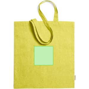 A bright yellow tote bag with long handles featuring a blank green square. The bag has a logo on one side.