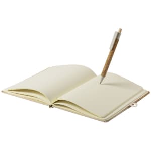 An open notepad with blank cream pages and a cork pen resting in it, featuring a simple design and a logo.