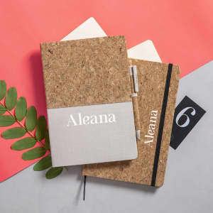 A cork notepad set featuring a grey fabric strip, with a sleek design and the presence of a logo.