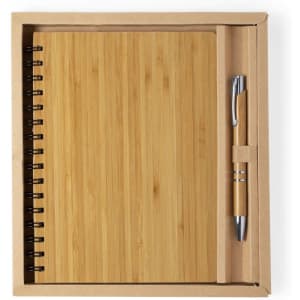 A bamboo notebook with a spiral binding and a pen, presented in a cardboard box.