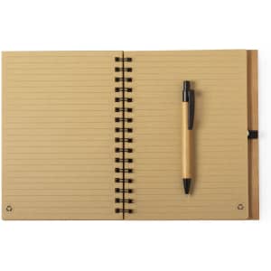 A tan notebook with lined pages, spiral binding, and a black pen placed on the right side.