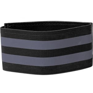 A black reflective armband featuring grey stripes, designed as a clothing accessory. It has a logo.