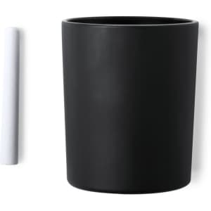 A black ceramic candle holder with a white stick beside it. The holder has a sleek, matte finish.