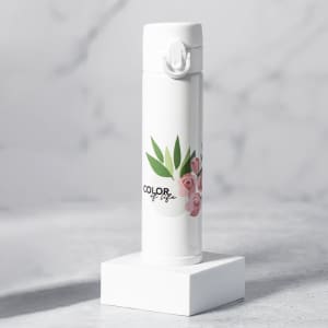 A drink bottle in white with floral design features a logo and is displayed on a white stand.