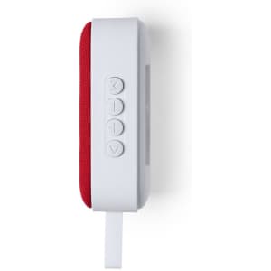 A compact speaker in white and red, featuring control buttons and a strap for easy carrying.
