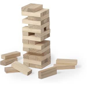 A wooden stacking game with light-coloured blocks arranged in a tower and scattered pieces nearby.