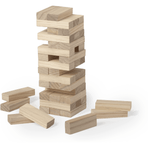 A wooden block game tower with several blocks stacked and scattered around, featuring a natural finish.
