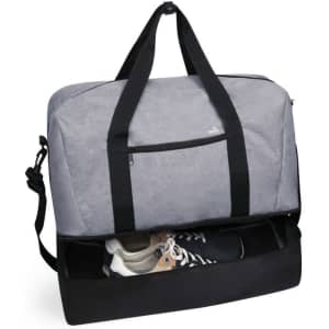 A grey duffle bag with black straps, featuring a separate compartment for shoes at the bottom.