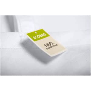 A white tote bag with reinforced handles and a tag indicating it is 100% compostable.