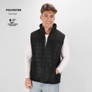 A black and grey soft shell vest made of polyester, featuring a high collar and a zip front, worn by a smiling model.
