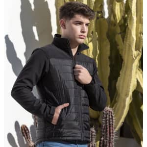A soft shell jacket in black, featuring a zippered front and side pockets, with a textured upper section.