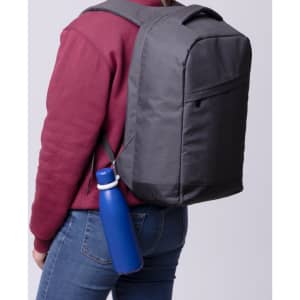 A grey backpack is worn by a person, featuring a blue drink bottle attached to the side.