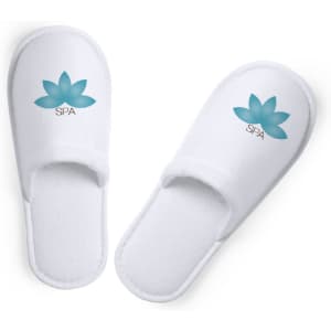 White slippers with a blue lotus design and "SPA" branding. Soft fabric and open-toe style for comfort.