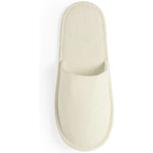 A pair of cream-coloured Nalton slippers with a simple, minimalist design. They have a soft, textured finish and a logo.