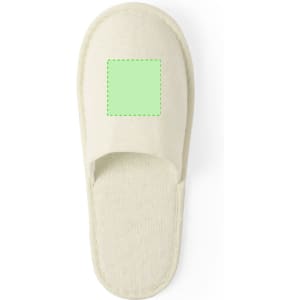 A light beige slipper featuring a blank green square on the upper section and a soft, textured footbed.