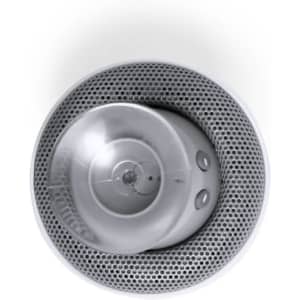 A circular grey speaker with a mesh grille and buttons on a white background, featuring a logo.