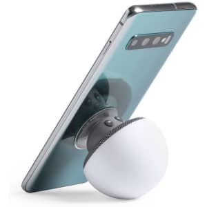 A white spherical speaker attached to a smartphone with a blue-green back. The speaker has a mesh design at the base.