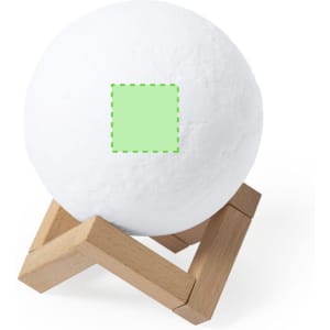 A white spherical speaker on a wooden stand. The speaker features a green highlighted area.