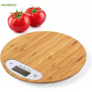 A bamboo weighing scale with a digital display, alongside two red tomatoes. The scale has a circular design.