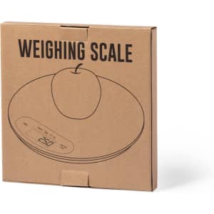 A weighing scale in a brown cardboard box featuring an illustration of an apple and a logo on the packaging.