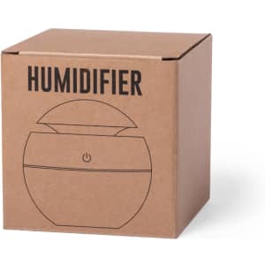 A brown cardboard box containing a round humidifier design, featuring a logo on the front.