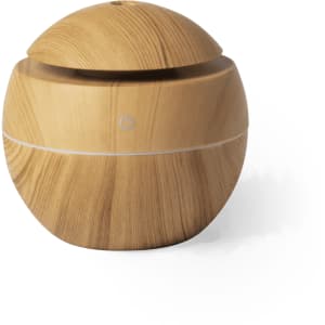 A wooden-effect humidifier with a round design, featuring a power button and a sleek, minimalistic look.