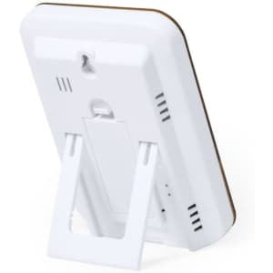 A white weather station with a stand, featuring a sleek design and a contrasting wood-like border.