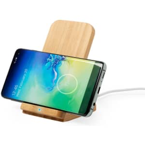 A wireless charger made of bamboo, featuring a sleek design and a smartphone positioned on it.