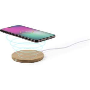 A wireless charger with a wooden base and a smartphone above it, displaying a vibrant screen illumination.