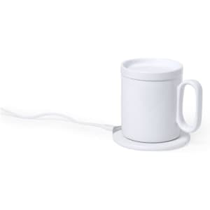 A white charger cup warmer with a handle and a round base, connected by a power cord.