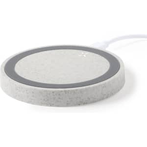A circular wireless charger in a light grey speckled design with a black charging surface and a white cable.