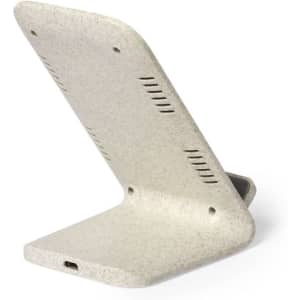 A wireless charger in a light grey colour with a textured surface and an angled design for easy phone placement.