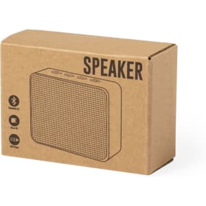 A cardboard box containing a Bluetooth speaker with a mesh speaker grille and several buttons on top.