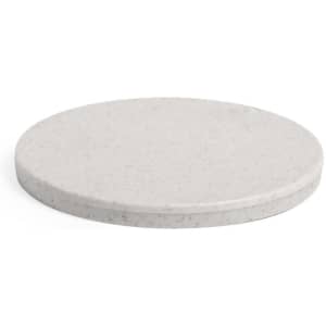 A round, white pocket mirror with a smooth surface and subtle speckling details. Features a logo on the back.